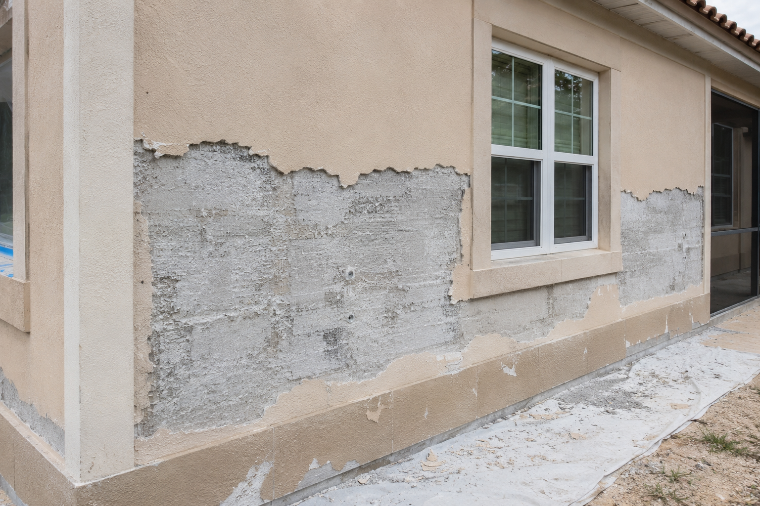 Stucco damage requiring repair before texture coating in Lakeland FL